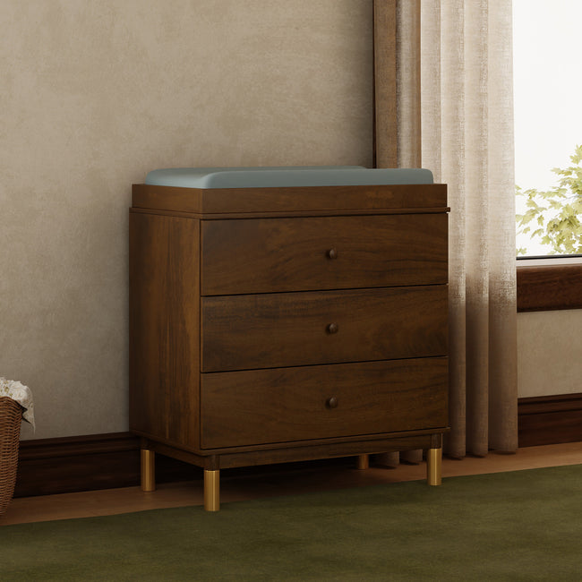 M12923NLGLD,Babyletto,Gelato 3-Drawer Changer Dresser  Gold Feet w/Removable Changing Tray in Natural Walnut